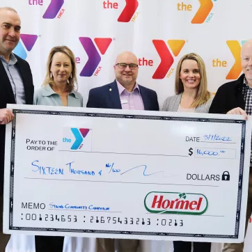 Check presentation photo: (left to right) Curtis Southard, Dold Foods Plant General Manager, Andrea Eliot, Greater Wichita YMCA Child Care and Camp Branch Director, David Foster, Richard A. DeVore South YMCA Branch Director, Hillary Hoesch, Greater Wichita YMCA Associate Vice President of Philanthropy, Ronn McMahon, Greater Wichita YMCA President and CEO